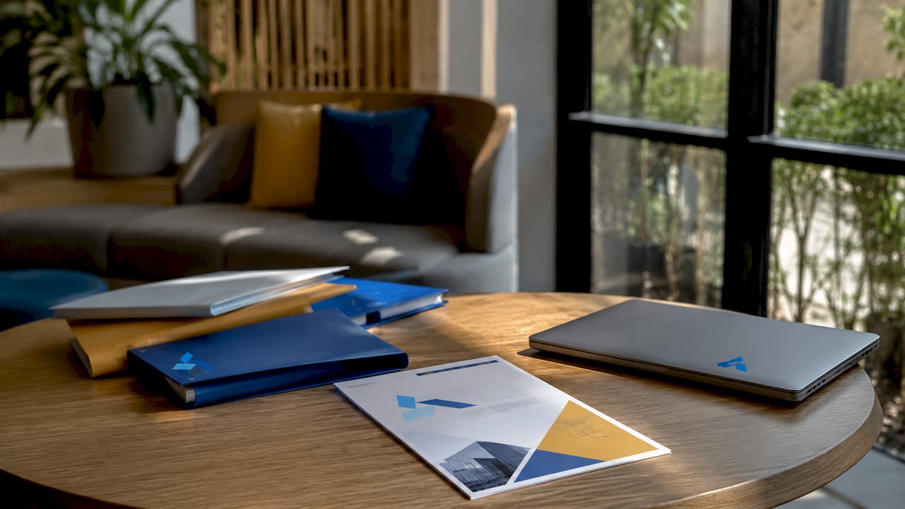 Overhead view of strategy documents and Blue Prysm logo