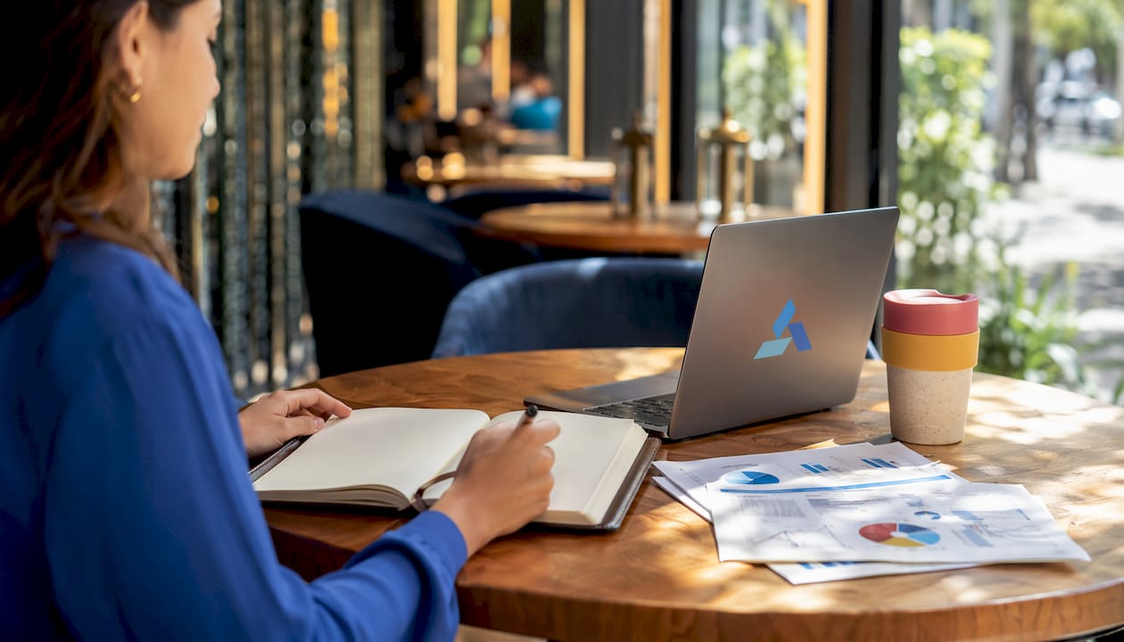 Workspace with notebook and Blue Prysm logo