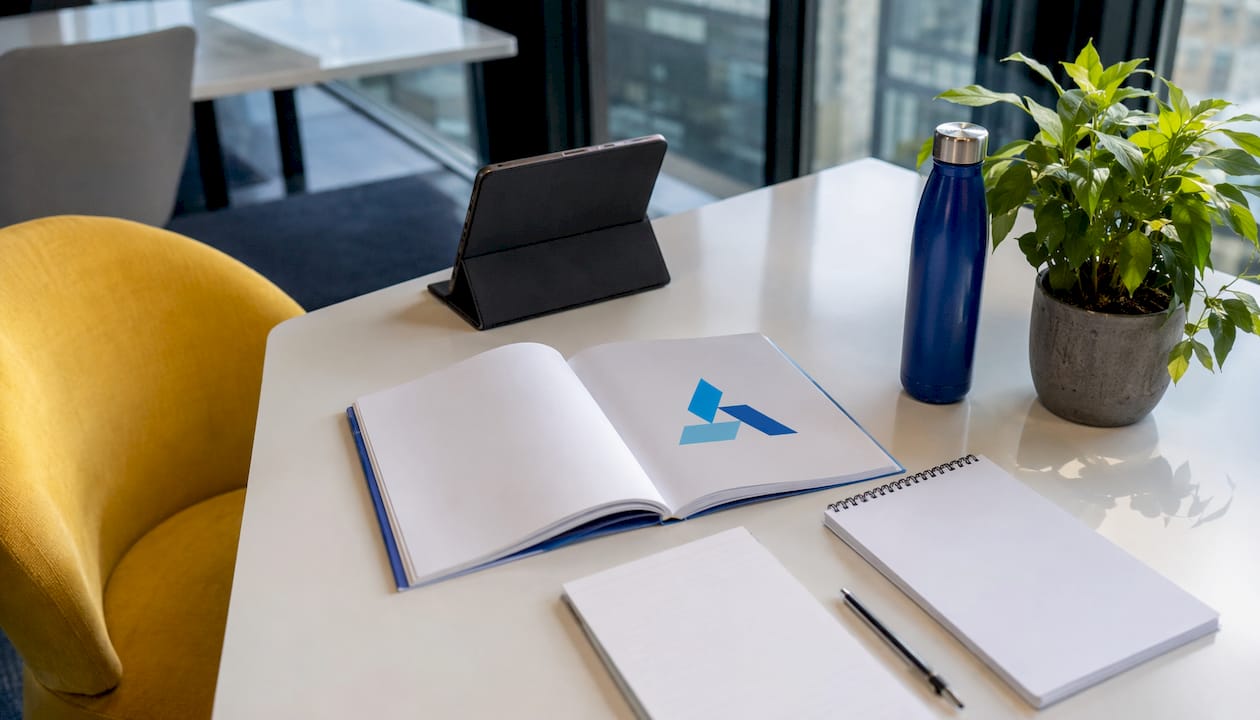 Business strategy workspace with Blue Prysm logo booklet